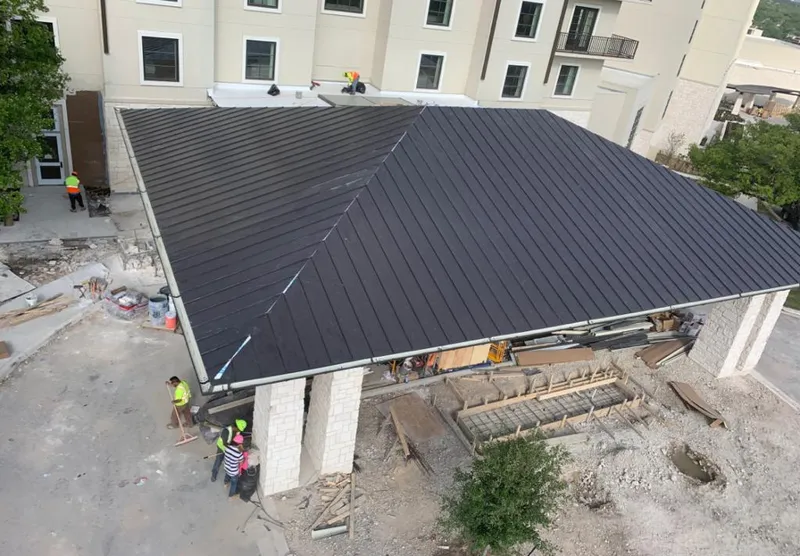 Metal roofing installation team working on a commercial building in Lower Nazareth